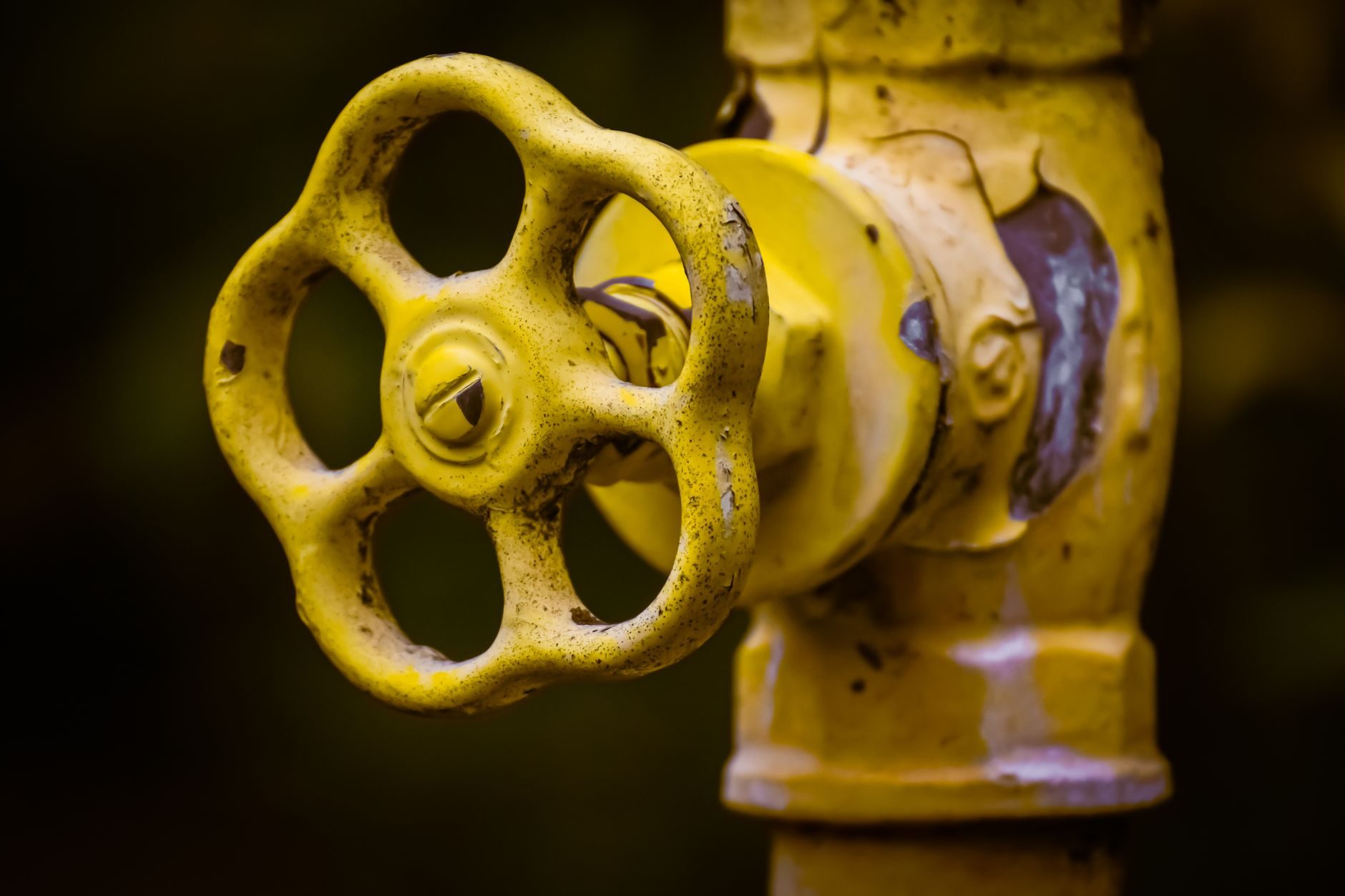 Close-up of a yellow industrial valve handwheel